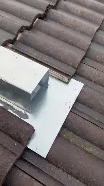Metal flashing and a one way door on a tiled roof